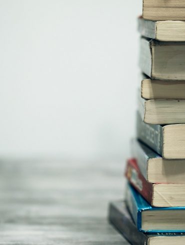 assorted books on wooden table