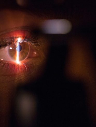 person with lighted cigarette in mouth
