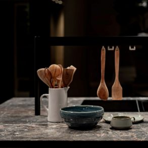 brown wooden spoon on blue ceramic bowl