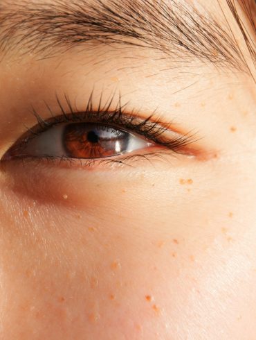 a close up of a woman's brown eye