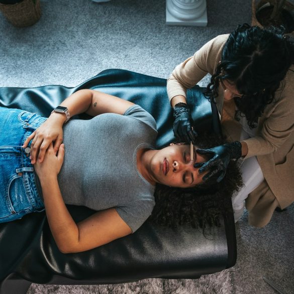 a woman getting her hair done by a hair stylist
