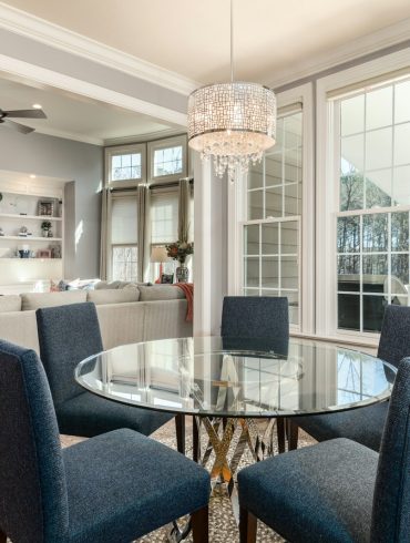 round clear glass-top table and five gray chairs dining se