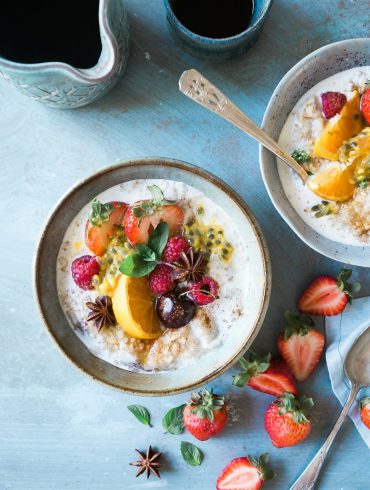 two bowls of oatmeal with fruits