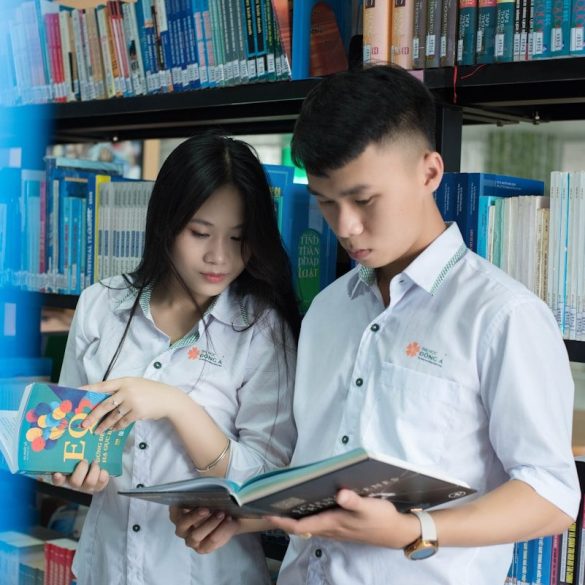 a man and a woman looking at a book